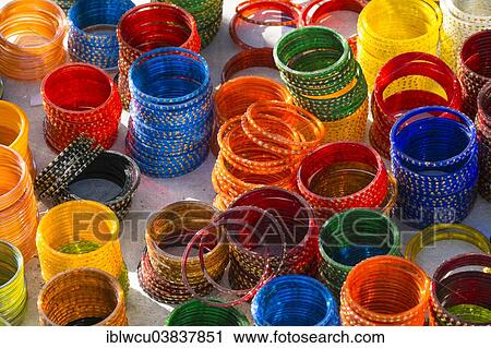 Stock Image - Colourful bangles on sale at a market stall. Fotosearch
