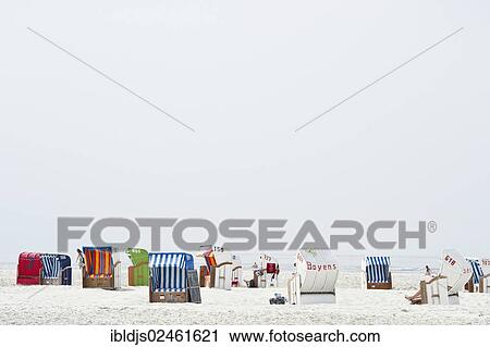Stock Image - "Colourful beach chairs, Norddorf, Amrum, North Frisian Islands, Schleswig-Holstein, Germany, Europe". Fotosearch