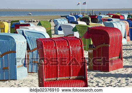 Stock Image - "Colourful beach chairs on the beach of Utersum, Foehr island, North Frisia, Schleswig-Holstein, Germany, Europe". Fotosearch