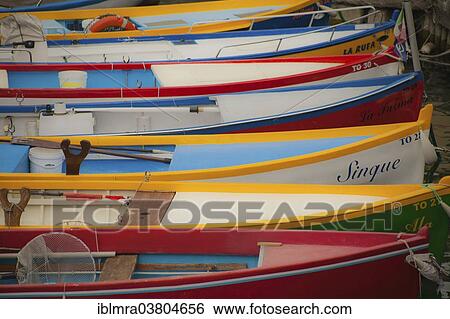 Stock Photograph - "Colourful fishing boats in a small harbour of Lake Garda, Torri del Benaco, Italy, Europe". Fotosearch