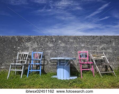 "Colourful group of seats against a wall with an old cable drum as a table, France, Europe" View Large Photo Image Stock Image - "Colourful group of seats against a wall with an old cable drum as a table, France, Europe". Fotosearch