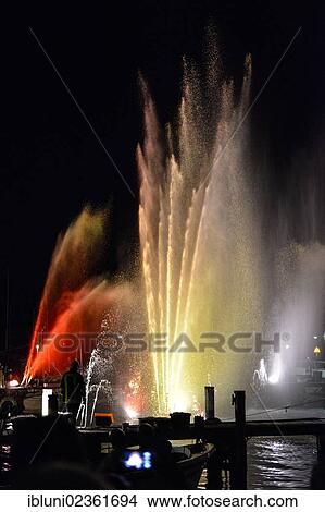"Colourful illuminated fountains at the Harbour Festival in Maasholm, Schleswig-Holstein, Germany, Europe" View Large Photo Image Picture - "Colourful illuminated fountains at the Harbour Festival in Maasholm, Schleswig-Holstein, Germany, Europe". Fotosearch