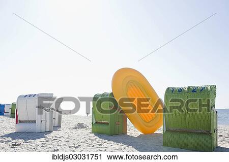 "Colourful roofed wicker beach chairs and a yellow inflatable boat, Amrum, North Frisian Islands, Schleswig-Holstein, Germany, Europe" View Large Photo Image Stock Image - "Colourful roofed wicker beach chairs and a yellow inflatable boat, Amrum, North Frisian Islands, Schleswig-Holstein, Germany, Europe". Fotosearch
