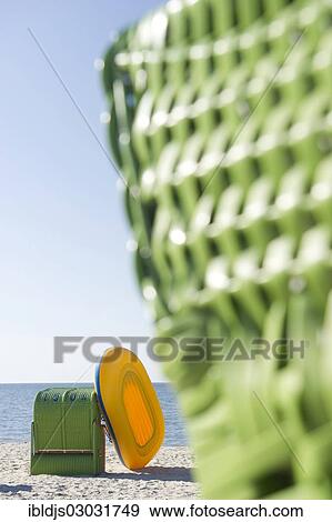 "Colourful roofed wicker beach chairs and a yellow inflatable boat, Amrum, North Frisian Islands, Schleswig-Holstein, Germany, Europe" View Large Photo Image Stock Photo - "Colourful roofed wicker beach chairs and a yellow inflatable boat, Amrum, North Frisian Islands, Schleswig-Holstein, Germany, Europe". Fotosearch