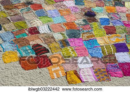 Stock Image - "Colourful saris laying to dry after washing on a sandbank on the banks of the Yamuna River, Yamuna, Agra, Uttar Pradesh, India, Asia". Fotosearch