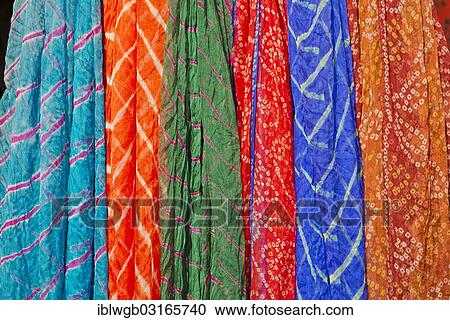 Stock Image - "Colourful silk scarves are displayed for sale, Pushkar, Rajasthan, India, Asia". Fotosearch