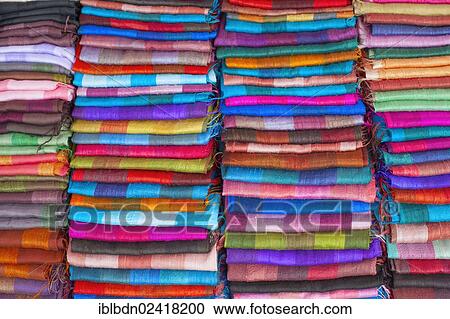 Stock Image - Colourful silk textiles on display at a market stall in Luang Prabang, Laos, Southeast Asia, Asia. Fotosearch
