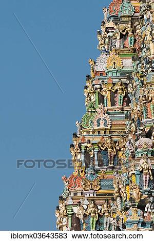 Stock Image - "Colourful statues of gods and demons on the Gopuram or Gopura gate tower, Meenakshi Amman Temple or Sri Meenakshi Sundareswarar Temple, Madurai, Tamil Nadu, India, Asia". Fotosearch