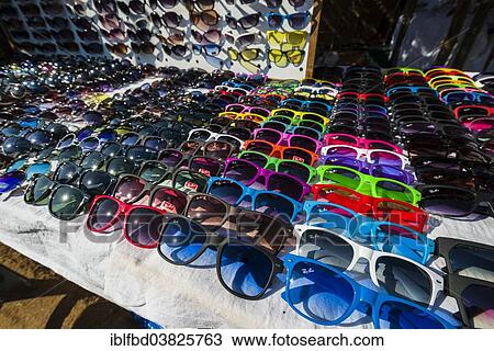 Stock Image - "Colourful sunglasses for sale at the weekly flea market, Anjuna, Goa, India, Asia". Fotosearch