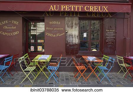Stock Photography - "Colourful tables and chairs outside the street cafe """"Au Petit Creux"""", Montmartre, Paris, Ile-de-France, France, Europe". Fotosearch