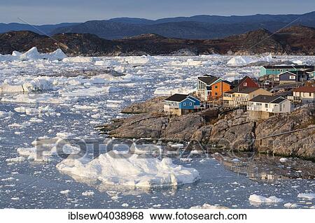 "Colourful timber houses by the sea with iceberg fragments, Ilulissat, Greenland, North America" View Large Photo Image Stock Photo - "Colourful timber houses by the sea with iceberg fragments, Ilulissat, Greenland, North America". Fotosearch