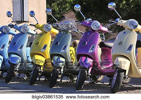 Stock Photography - "Colourful Vespas as rental vehicles, Saint-Tropez, Var, Provence-Alpes-Cote d'Azur, France, Europe". Fotosearch