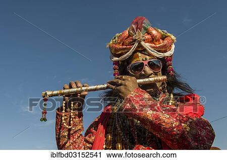 "Colourfully costumed devotee playing flute during Kumbh Mela, Allahabad, Uttar Pradesh, India, Asia" View Large Photo Image Stock Image - "Colourfully costumed devotee playing flute during Kumbh Mela, Allahabad, Uttar Pradesh, India, Asia". Fotosearch