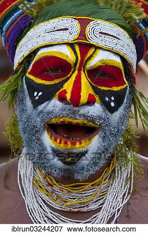 Stock Photo - "Colourfully decorated and painted man celebrating the traditional Sing Sing in the highlands, Enga, Highlands, Papua New Guinea, Oceania". Fotosearch