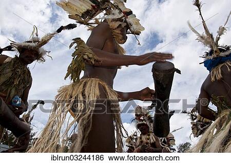 Stock Photograph - "Colourfully decorated and painted tribes celebrating the traditional Sing Sing in the highlands, Enga, Highlands, Papua New Guinea, Oceania". Fotosearch