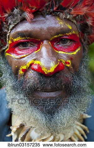 "Colourfully decorated man with face paint is celebrating at the traditional Sing Sing gathering in the highlands, Paya, Papua New Guinea, Oceania" View Large Photo Image Stock Photography - "Colourfully decorated man with face paint is celebrating at the traditional Sing Sing gathering in the highlands, Paya, Papua New Guinea, Oceania". Fotosearch