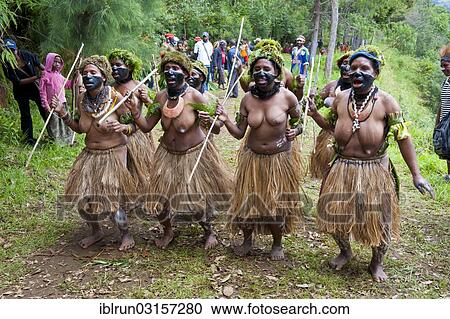 Stock Image - "Colourfully decorated women with face paint are celebrating at the traditional Sing Sing gathering in the highlands, Paya, Papua New Guinea, Oceania". Fotosearch