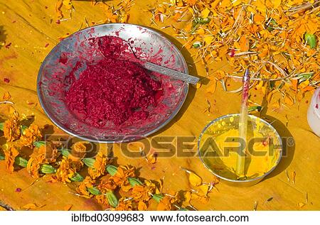 Stock Image - "Colourpowder and coloured rice on yellow material to work with as a priest, Kathmandu, Kathmandu District, Bagmati Zone, Nepal, Asia". Fotosearch