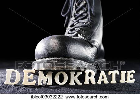 "Combat boot on the word """"Demokratie"""", German for """"Democracy"""", symbolic image for right-wing extremism" View Large Photo Image Stock Image - "Combat boot on the word """"Demokratie"""", German for """"Democracy"""", symbolic image for right-wing extremism". Fotosearch