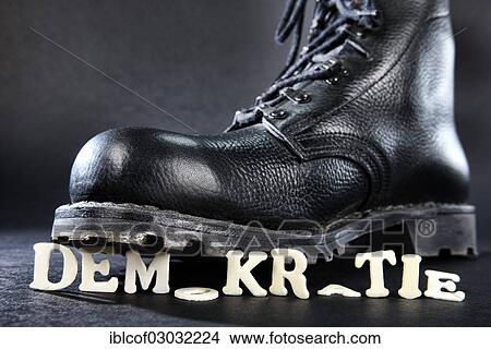"Combat boot standing on the word """"Demokratie"""", German for """"democracy"""", symbolic image of right-wing extremism, Germany, Europe" View Large Photo Image Picture - "Combat boot standing on the word """"Demokratie"""", German for """"democracy"""", symbolic image of right-wing extremism, Germany, Europe". Fotosearch
