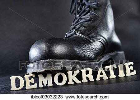 "Combat boot standing on the word """"Demokratie"""", German for """"democracy"""", symbolic image of right-wing extremism, Germany, Europe" View Large Photo Image Stock Image - "Combat boot standing on the word """"Demokratie"""", German for """"democracy"""", symbolic image of right-wing extremism, Germany, Europe". Fotosearch