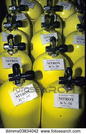 Stock Image - Compressed air cylinders or scuba tanks with Nitrox for diving. Fotosearch