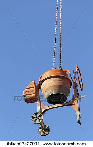 "Concrete mixer hanging from a crane, theft protection on a construction site" View Large Photo Image Stock Image - "Concrete mixer hanging from a crane, theft protection on a construction site". Fotosearch