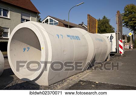"Concrete pipes for the renewal of the sewerage system, construction site for road rehabilitation, Koenigstrasse, Kamen, Ruhr Area, North Rhine-Westphalia, Germany, Europe, PublicGround, Europe" View Large Photo Image Stock Image - "Concrete pipes for the renewal of the sewerage system, construction site for road rehabilitation, Koenigstrasse, Kamen, Ruhr Area, North Rhine-Westphalia, Germany, Europe, PublicGround, Europe". Fotosearch
