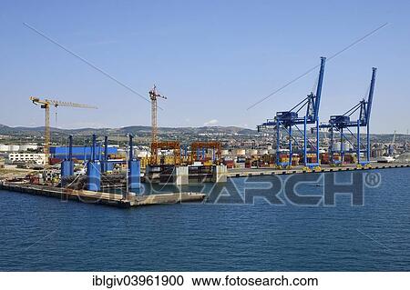"Construction cranes and container handling gantry cranes in the port of Civitavecchia, Province of Rome, Lazio, Italy, Europe" View Large Photo Image Stock Image - "Construction cranes and container handling gantry cranes in the port of Civitavecchia, Province of Rome, Lazio, Italy, Europe". Fotosearch