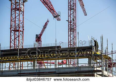 Stock Photo - "Construction cranes at a construction site, construction site of the Hochschule Ruhr-West University of Applied Sciences, Mulheim, North Rhine-Westphalia, Germany, Europe". Fotosearch