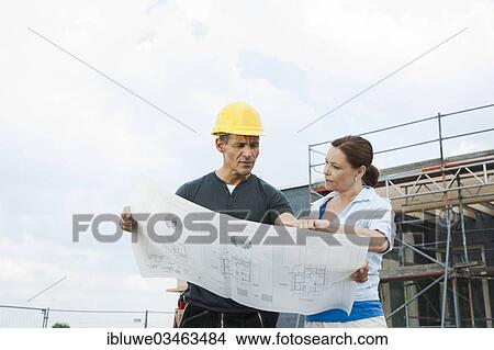 Picture - "Construction manager and building owner discussing plans on a construction site, Mannheim, Baden-Wurttemberg, Germany, Europe". Fotosearch