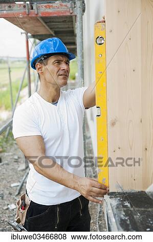 "Construction manager controlling the window installation with a spirit level, Mannheim, Baden-Wurttemberg, Germany, Europe" View Large Photo Image Stock Photo - "Construction manager controlling the window installation with a spirit level, Mannheim, Baden-Wurttemberg, Germany, Europe". Fotosearch