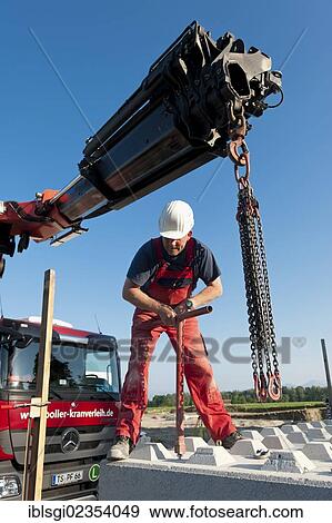 Stock Photo - "Construction worker at a building site in Fridolfing, Bavaria, Germany, Europe". Fotosearch