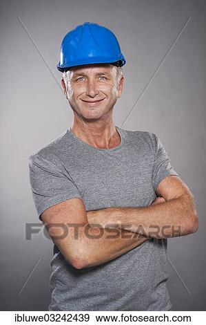 Stock Photo - "Construction worker wearing a hard hat, Mannheim, Baden-Wurttemberg, Germany, Europe". Fotosearch