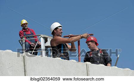 "Construction workers on a building site in Fridolfing, Bavaria, Germany, Europe" View Large Photo Image Stock Photo - "Construction workers on a building site in Fridolfing, Bavaria, Germany, Europe". Fotosearch
