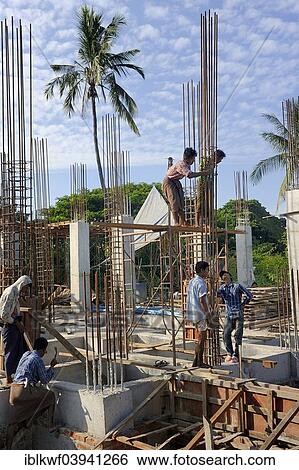 Stock Photograph - "Construction workers on a high rise construction site wire rebar, Mandalay, Myanmar, Asia". Fotosearch