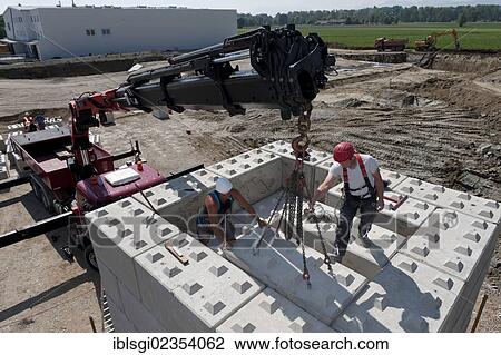 "Construction workers stacking blocks during a building site load test, construction site in Fridolfing, Bavaria, Germany, Europe" View Large Photo Image Stock Image - "Construction workers stacking blocks during a building site load test, construction site in Fridolfing, Bavaria, Germany, Europe". Fotosearch
