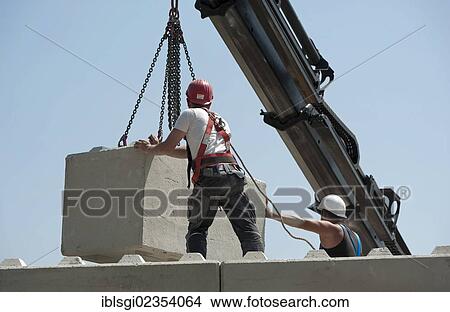 "Construction workers stacking concrete blocks during a building site load test, construction site in Fridolfing, Bavaria, Germany, Europe" View Large Photo Image Picture - "Construction workers stacking concrete blocks during a building site load test, construction site in Fridolfing, Bavaria, Germany, Europe". Fotosearch