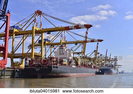 Stock Image - "Container ship and gantry cranes, Stromkaje quay, Wilhelm Kaisen Terminal, Container Terminal Bremerhaven, Bremerhaven, Bremen, Germany, Europe". Fotosearch