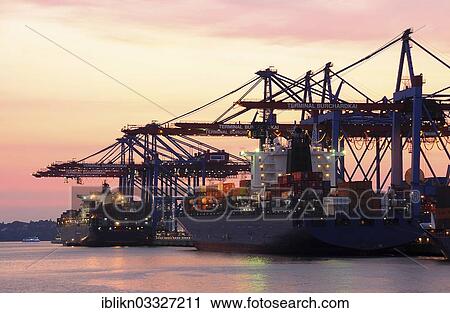 Stock Image - "Container ships in the port during loading, dusk, Waltershof, Hamburg, Hamburg, Germany, Europe". Fotosearch