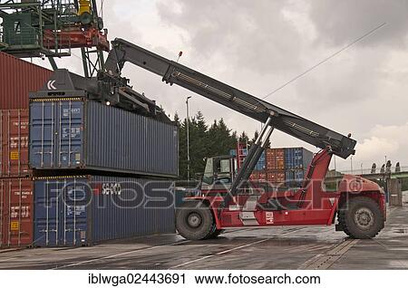 Stock Image - "Container terminal, Kalmar-spreader handling containers delivered by rail, Westkai container terminal, Cologne-Niehl, North Rhine-Westphalia, Germany, Europe". Fotosearch