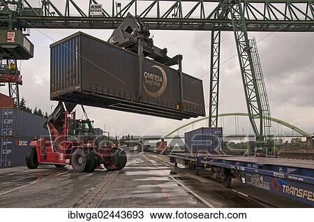 Stock Image - "Container terminal, Kalmar-Spreader handling containers delivered by rail, Westkai terminal, Cologne-Niehl, North Rhine-Westphalia, Germany, Europe". Fotosearch