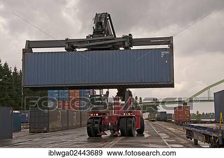 "Container terminal, Kalmar-Spreader handling containers delivered by rail, Westkai terminal, Cologne-Niehl, North Rhine-Westphalia, Germany, Europe" View Large Photo Image Stock Photo - "Container terminal, Kalmar-Spreader handling containers delivered by rail, Westkai terminal, Cologne-Niehl, North Rhine-Westphalia, Germany, Europe". Fotosearch