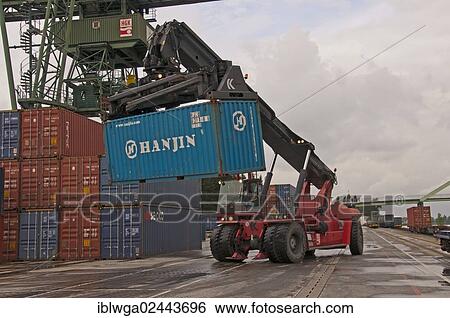 "Container terminal, Kalmar-Spreader handling containers delivered by rail, Westkai terminal, Cologne-Niehl, North Rhine-Westphalia, Germany, Europe" View Large Photo Image Stock Photograph - "Container terminal, Kalmar-Spreader handling containers delivered by rail, Westkai terminal, Cologne-Niehl, North Rhine-Westphalia, Germany, Europe". Fotosearch