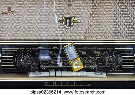 Contrast between an iPod and an old radio View Large Photo Image Picture - Contrast between an iPod and an old radio. Fotosearch