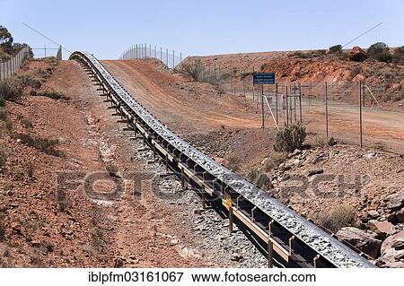 Stock Photo - "Conveyer band transporting rocks at a goldfield, Kalgoorlie, Western Australia, Australia, Oceania". Fotosearch