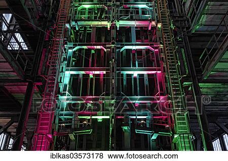Stock Photo - "Conveyor lifts of mine shaft No. 7, illuminated during ExtraSchicht, a night of industrial culture, disused coal mine of Zeche Ewald Colliery, Herten, Ruhr district, North Rhine-Westphalia, Germany, Europe". Fotosearch