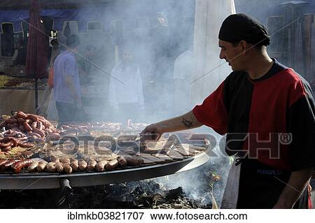"Cook handles giant barbecue at the annual All Saints Market in Cocentaina, Alicante province, Spain, Europe" View Large Photo Image Stock Photo - "Cook handles giant barbecue at the annual All Saints Market in Cocentaina, Alicante province, Spain, Europe". Fotosearch