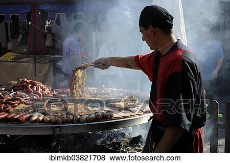 "Cook handles giant barbecue at the annual All Saints Market in Cocentaina, Alicante province, Spain, Europe" View Large Photo Image Stock Photo - "Cook handles giant barbecue at the annual All Saints Market in Cocentaina, Alicante province, Spain, Europe". Fotosearch