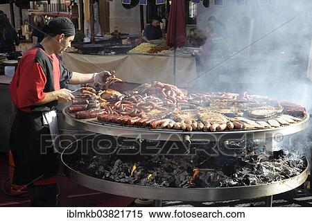 "Cook handles giant barbecue at the annual All Saints Market in Cocentaina, Alicante province, Spain, Europe" View Large Photo Image Stock Photography - "Cook handles giant barbecue at the annual All Saints Market in Cocentaina, Alicante province, Spain, Europe". Fotosearch